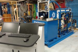 Test devices spin rig in facility with computers in foreground