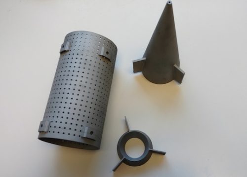 Three additive 3d printed parts during spin testing on white background